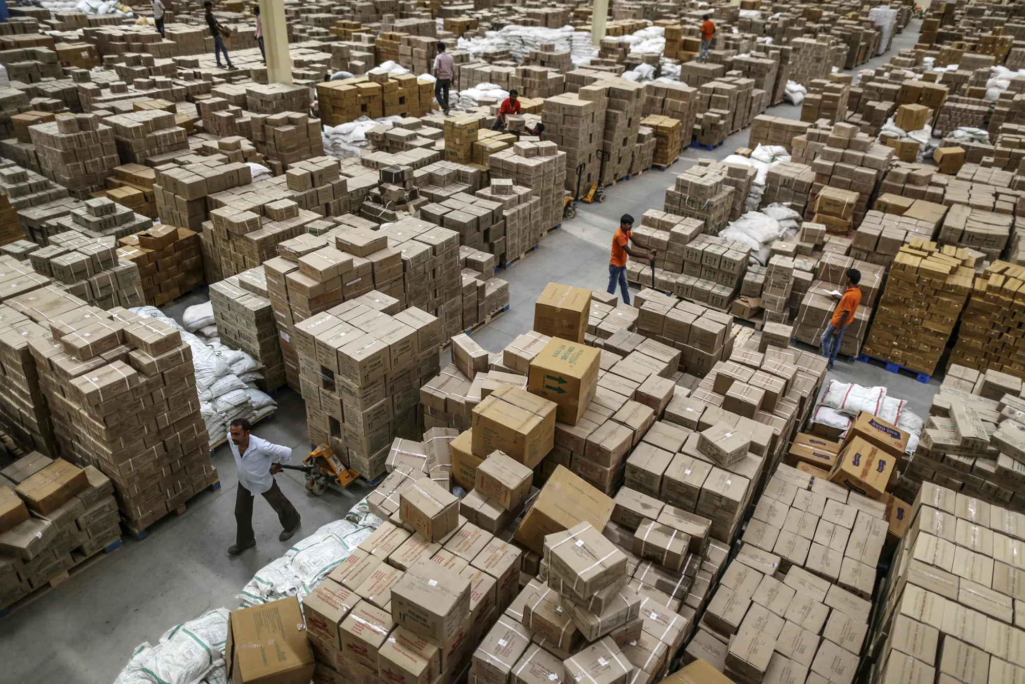 Employees work inside a warehouse operated by Patanjali Ayurved Ltd. near to the Multi-modal International Cargo Hub Airport at Nagpur (MIHAN) in Nagpur, India, on April 28, 2017.
