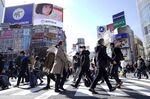 Pedestrians cross an intersection in the Shibuya district of Tokyo.