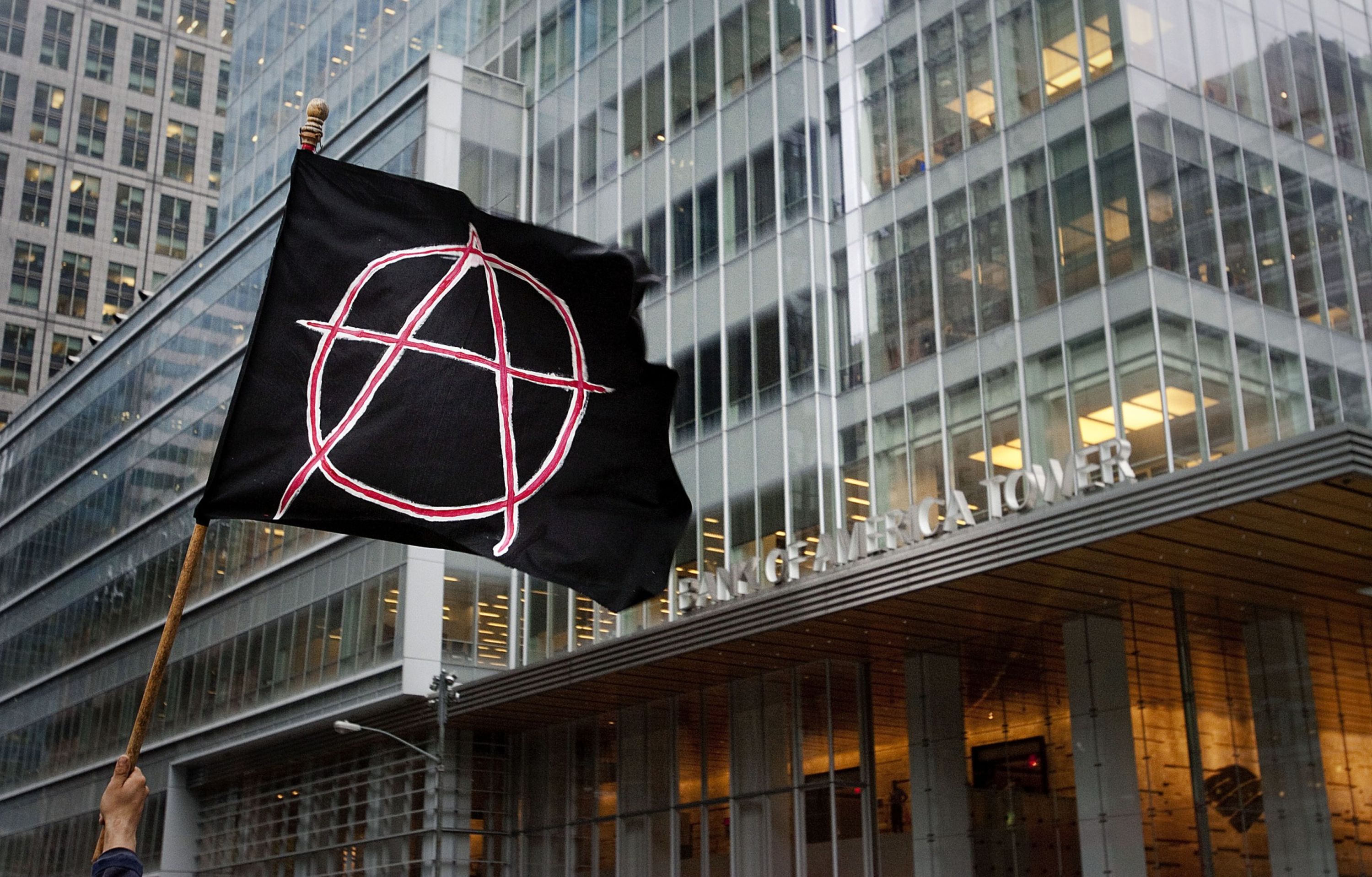 Greetings from the&nbsp;“anarchist jurisdiction” of New York City: A protester flies an anarchist flag over lower Manhattan&nbsp;— in 2012, during Occupy Wall Street demonstrations.&nbsp;