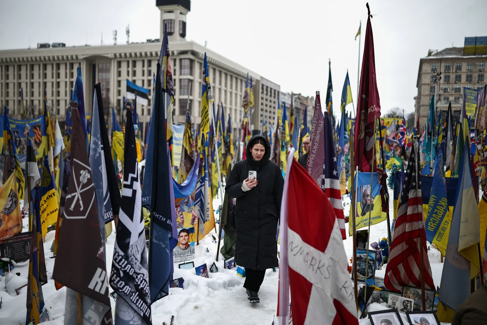 A person walks through a makeshift memorial to fallen Ukrainian and foreign soldiers in Kyiv on Feb. 23.