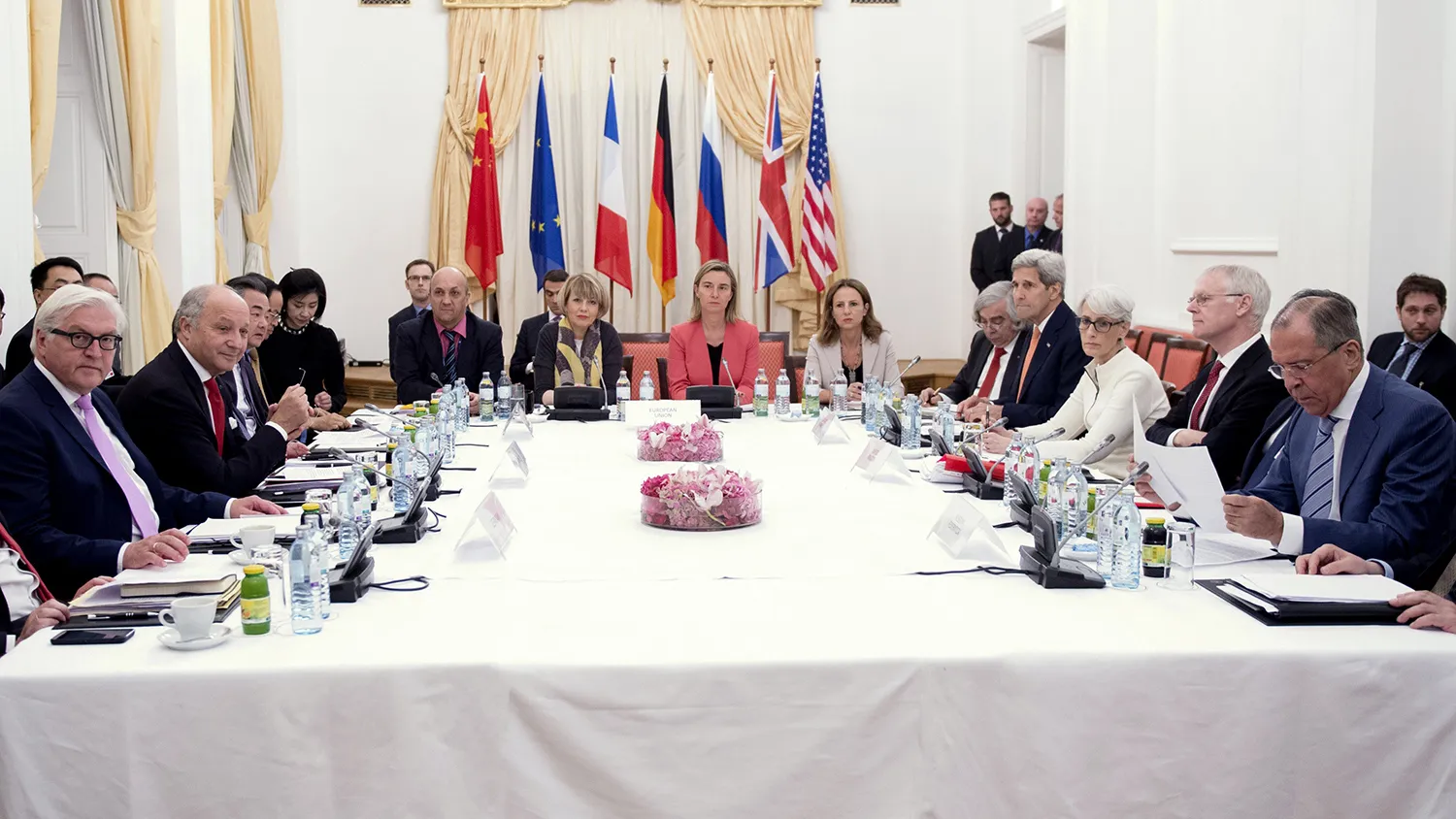 German Foreign Minister Frank-Walter Steinmeier (L), French Foreign Minister Laurent Fabius (2nd L), Chinese Foreign Minister Wang Yi (3rd L), European Union foreign policy chief Federica Mogherini (Centre in red), U.S. Secretary of State John Kerry (4th R) and Russian Foreign Minister Sergei Lavrov (R) meet at a hotel in Vienna July 13, 2015.
