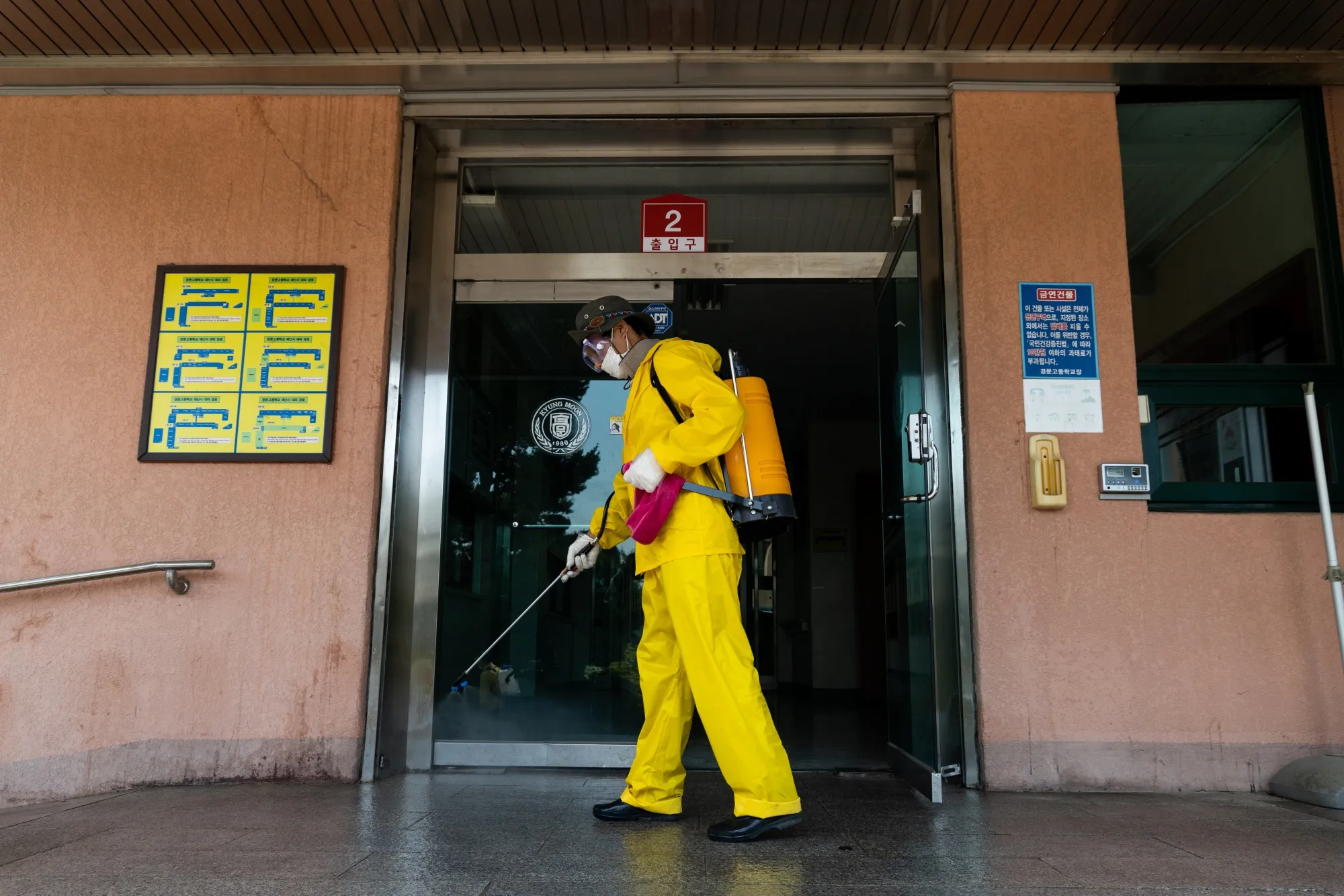 A worker&nbsp;sprays disinfectant outside a high school in the Dongjak district of Seoul, on May 29.