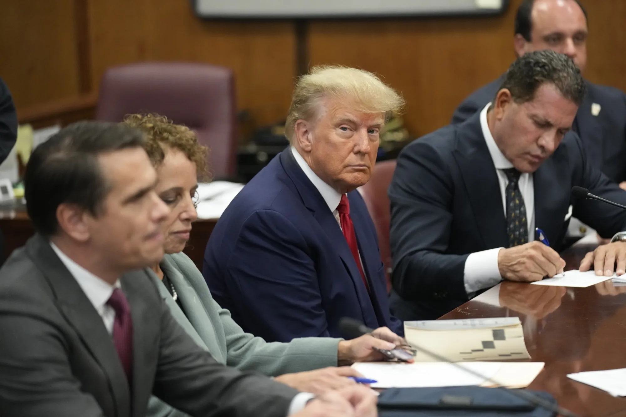 Donald Trump sits at the defense table with his attorneys during his arraignment in New York on April 4.&nbsp;