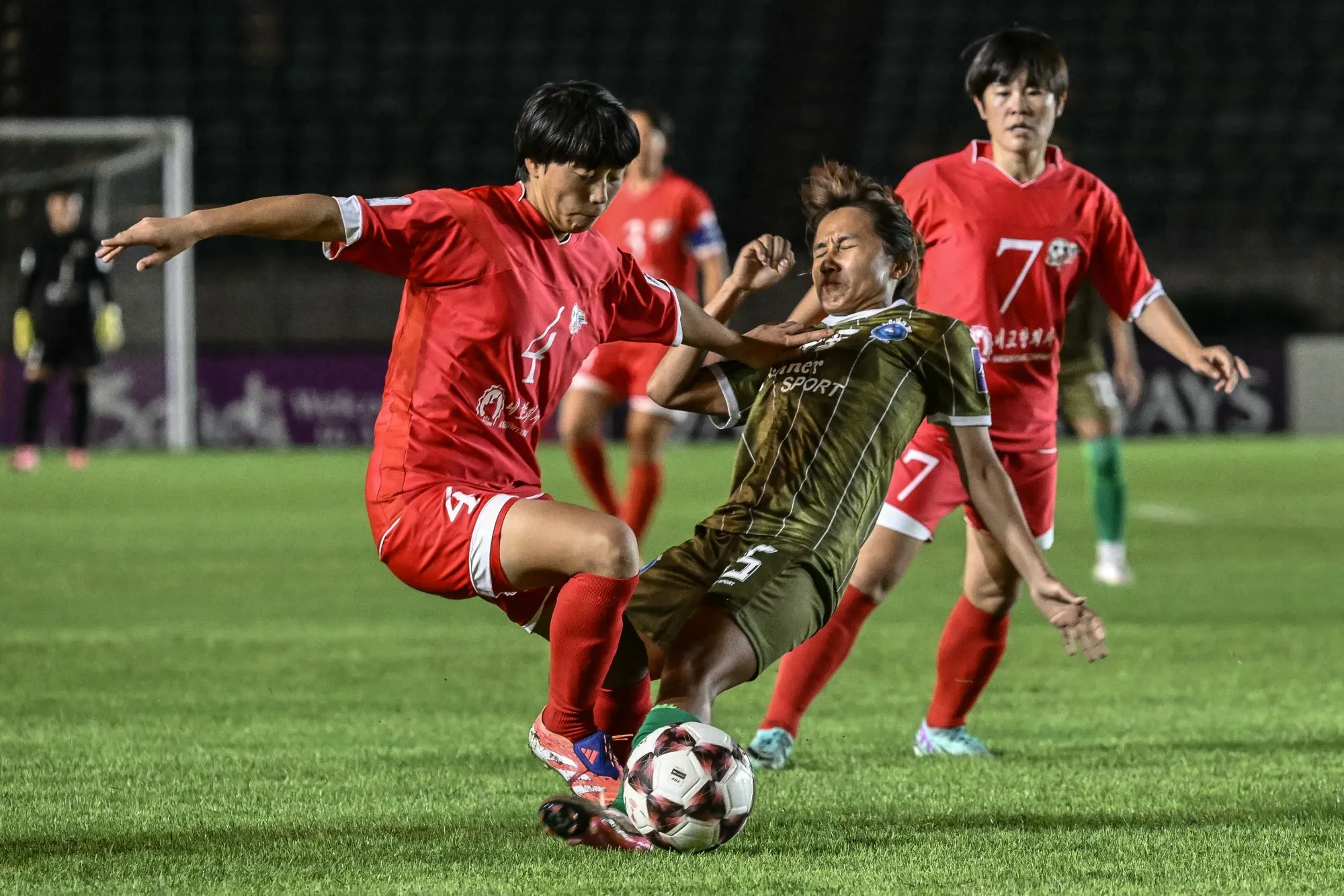 Ri Myong-Gum of Naegohyang Women's FC fights for the ball during an AFC Women's Champions League match in Yangon in 2025.