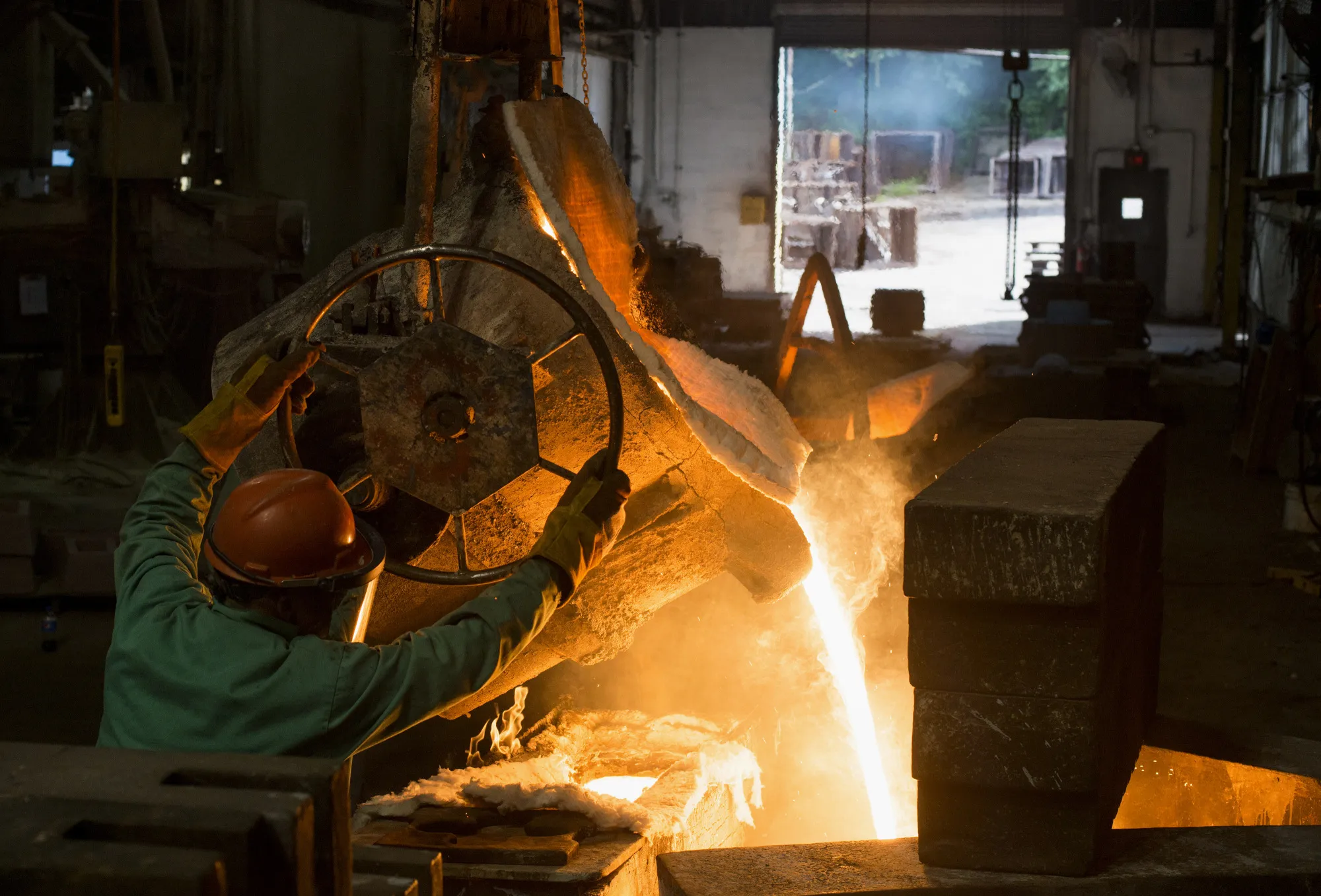 A worker pours molten metal from a furnace into a large ladle&nbsp;in Salem, Ohio.