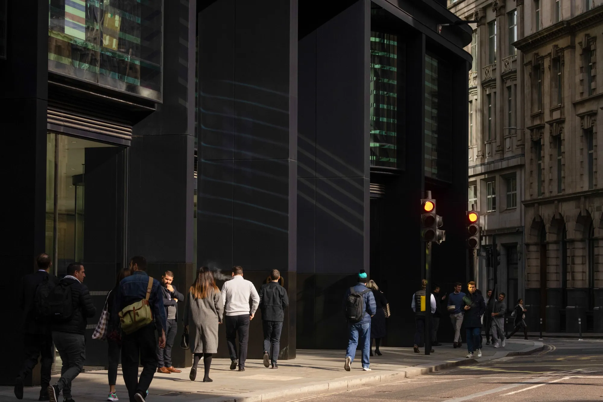 Workers walk through the City of London, UK, on Oct. 16.