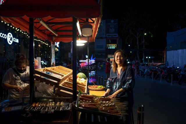 Yada Pornpetrumpa sells street food at her stall on Khaosan Road in Bangkok. Since Covid-19, she figures her daily income has fallen more than 90%.