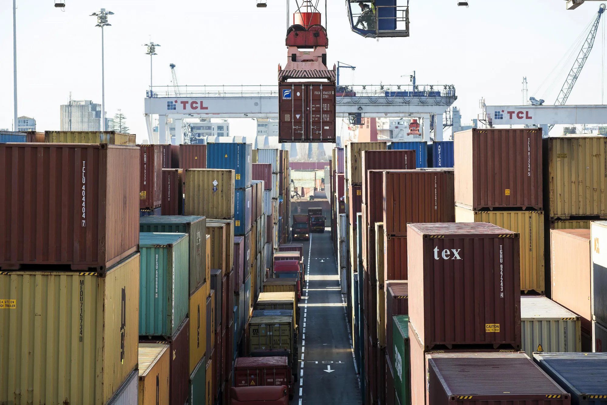 A crane positions a shipping container&nbsp;at the Port of Leixoes&nbsp;in Porto, Portugal.