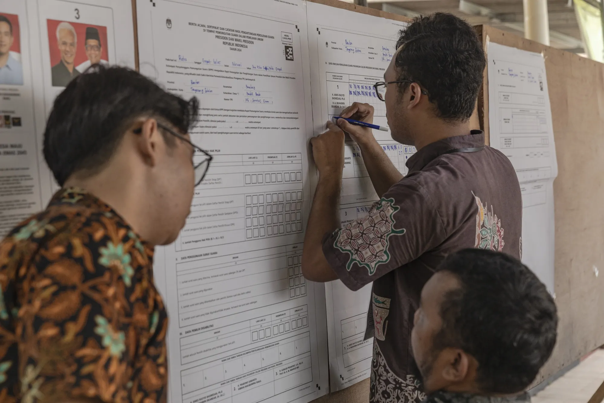 Electoral officials count ballots at a polling station in South Tangerang.