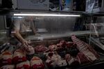 A butcher arranges meat at a store in Buenos Aires, Argentina, on Friday, Nov. 18, 2022. Argentina's annual inflation surged last month as the government implements price freezes on over a thousand consumer goods in attempt to cool cost-of-living increases. Photographer: Erica Canepa/Bloomberg