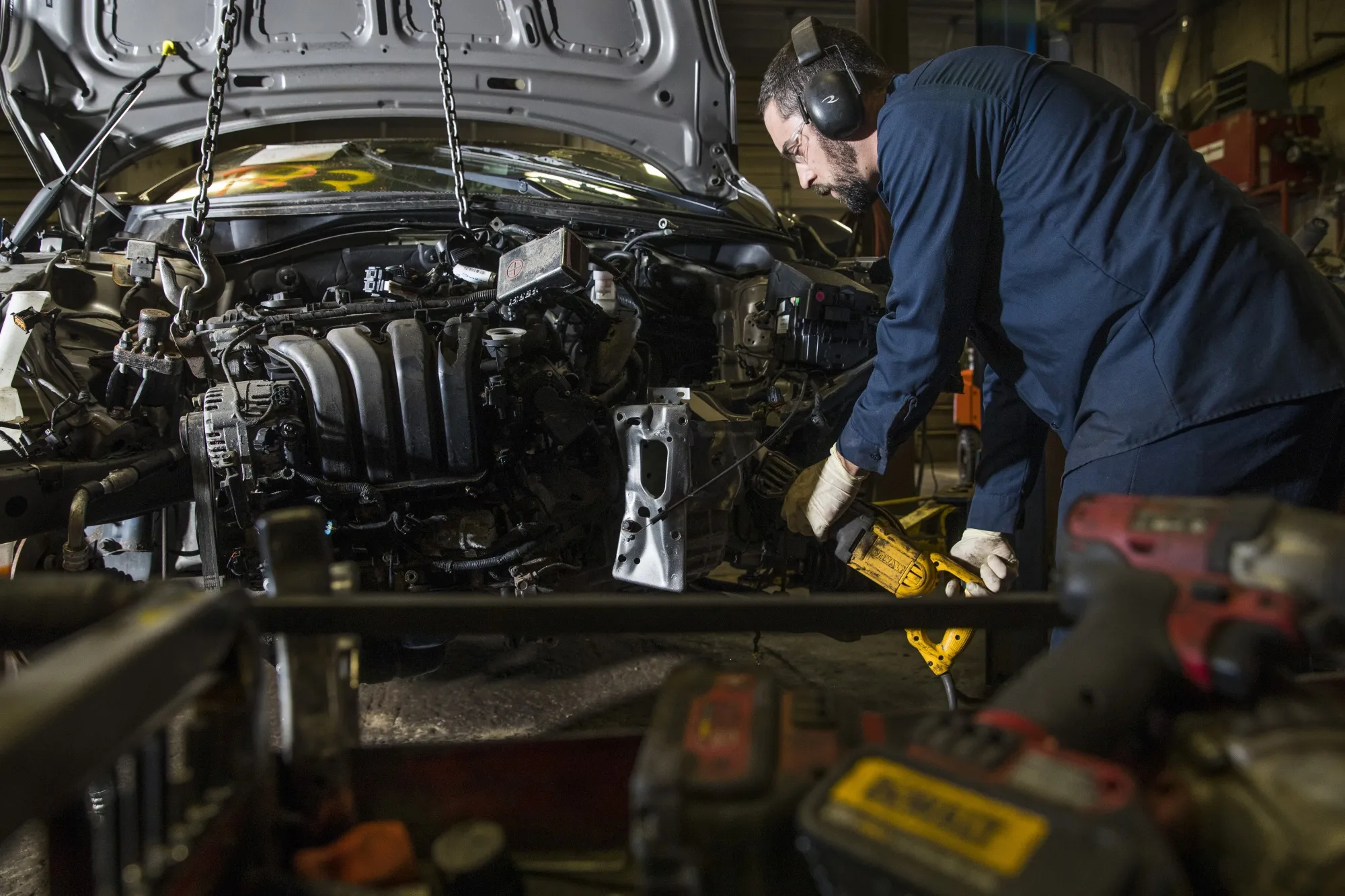 A worker disassembles a car at an auto garage&nbsp;in Wareham, Massachusetts.