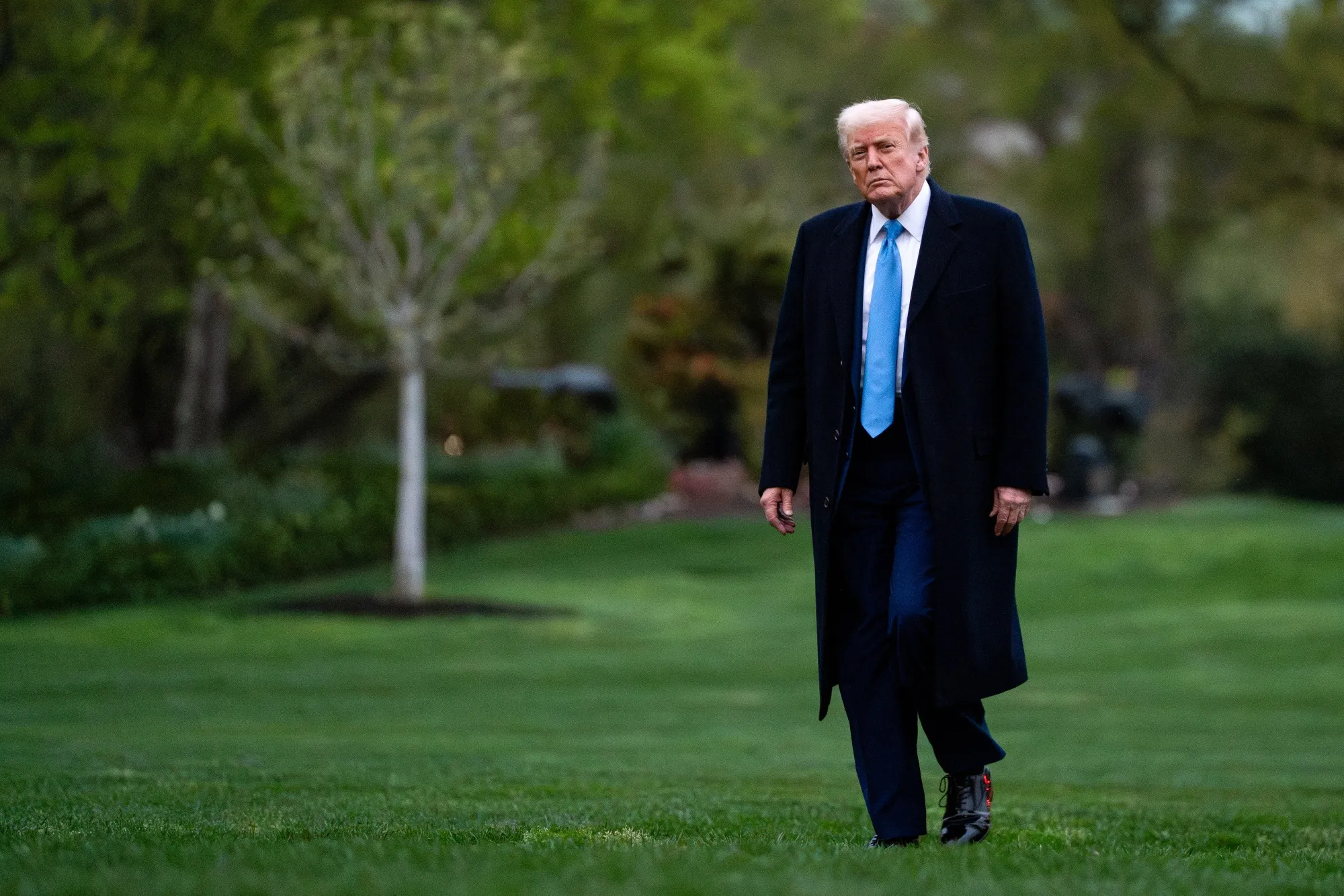 US President Donald Trump walks on the South Lawn of the White House after arriving on Marine One in Washington, DC, US, on Sunday, April 6, 2025. China’s objections to new US tariffs stalled a deal to sell off TikTok and keep it operating in the US, Trump said Sunday.