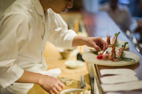 A chef prepares sashimi before it heads to the dining room at 15 East.