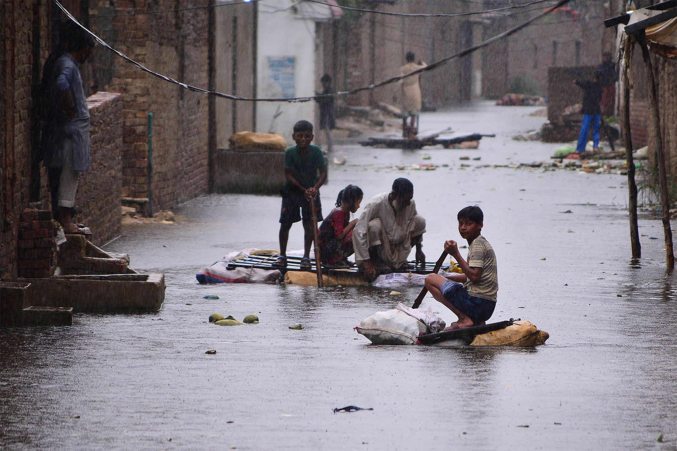 Residents use rafts to make their way along a flooded street in in Hyderabad, Pakistan, on Aug. 24.