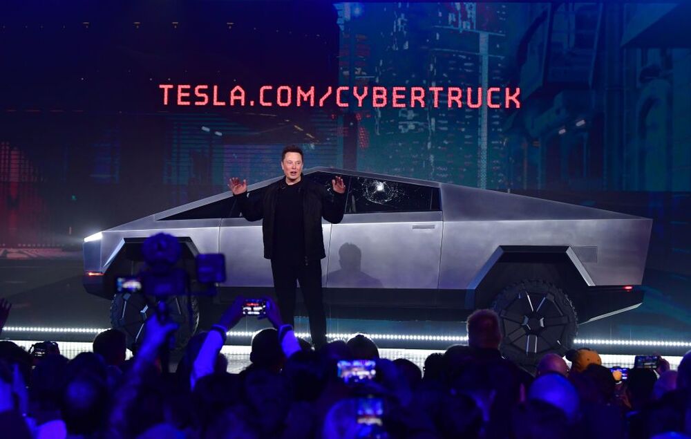Elon Musk speaks in front of the newly unveiled Cybertruck with shattered windows, after a failed resistance test on Nov. 21.