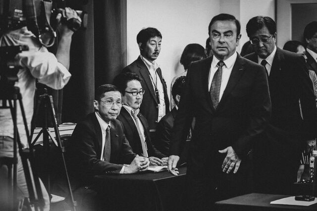 Ghosn, second right, walks past Saikawa, seated left, at a news conference in Yokohama, Japan, on May 12, 2016.
