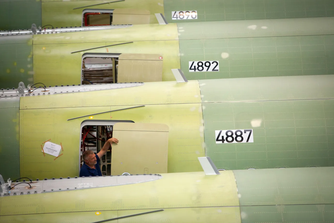 An employee works on an A320 aircraft at the Airbus factory in Hamburg.