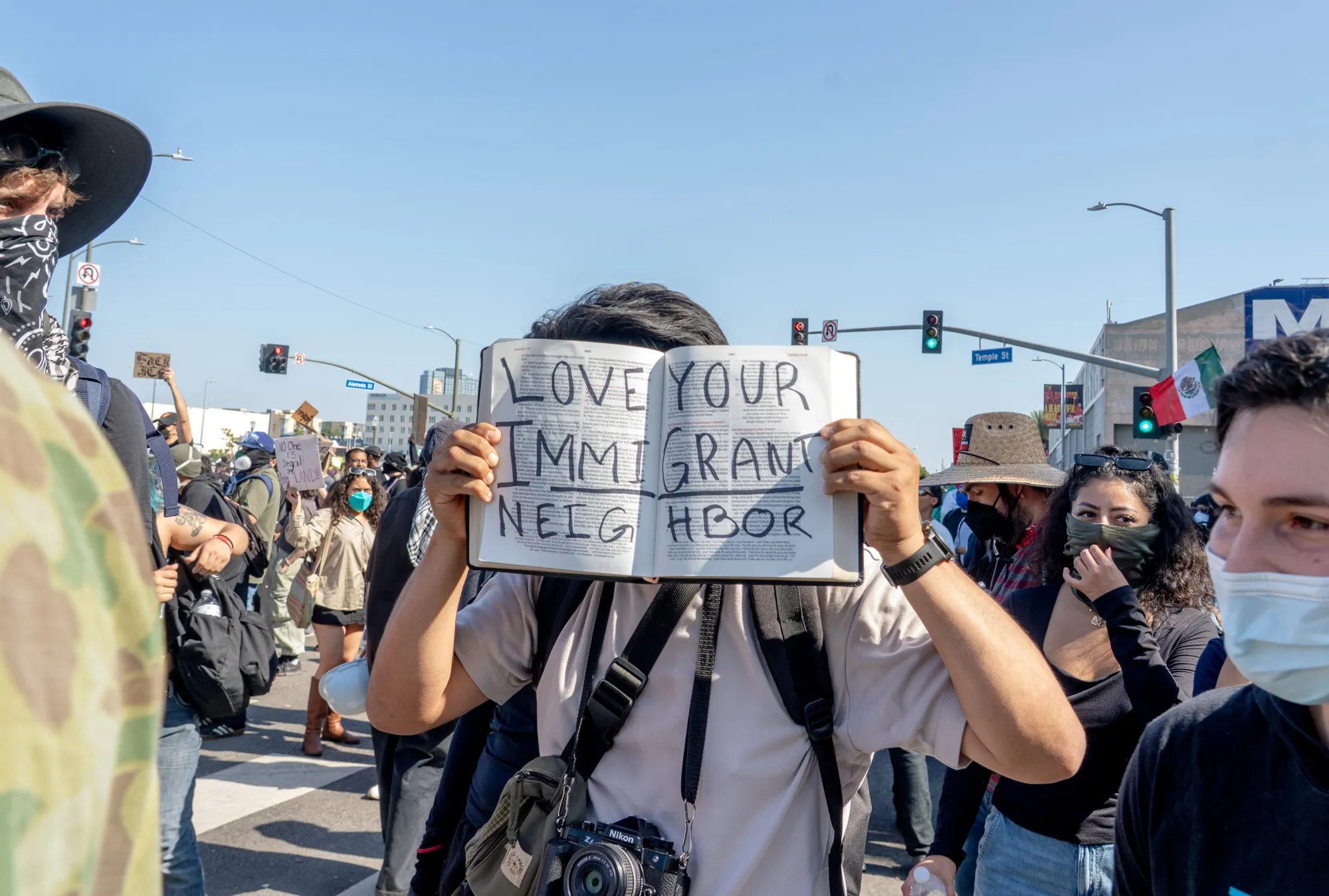 A protester holds a bible with the words "Love your immigrant neighbor" outside of the Edward R. Roybal Federal Building during a demonstration in Los Angeles on June 8.