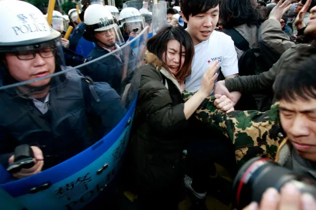 Students protesting against a China-Taiwan trade pact clash with riot police in Taipei, Taiwan, on March 24