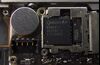 A Qualcomm Inc. baseband processor sits inside a smartphone sold as an Apple Inc. iPhone 4S in an arranged photograph in Hong Kong, China.