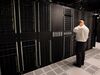 A public relations employee looks over racks of servers inside pod one of International Business Machines Corp.'s (IBM) Softlayer data center in Dallas.