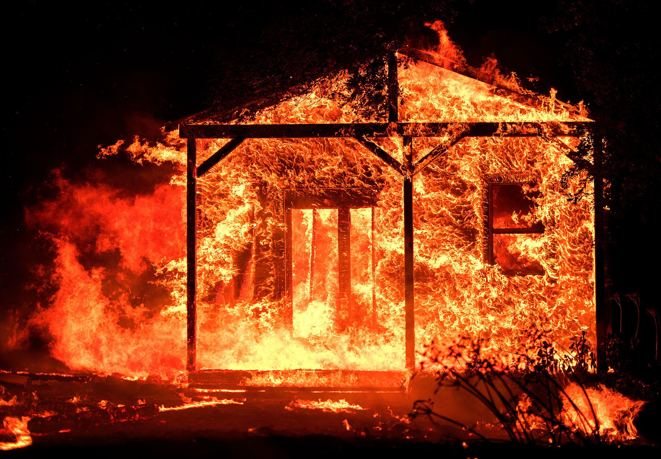 Flames overtake a structure as nearby homes burn in the Napa wine region in California on Oct. 9, 2017, as multiple wind-driven fires continue to whip through the region.

