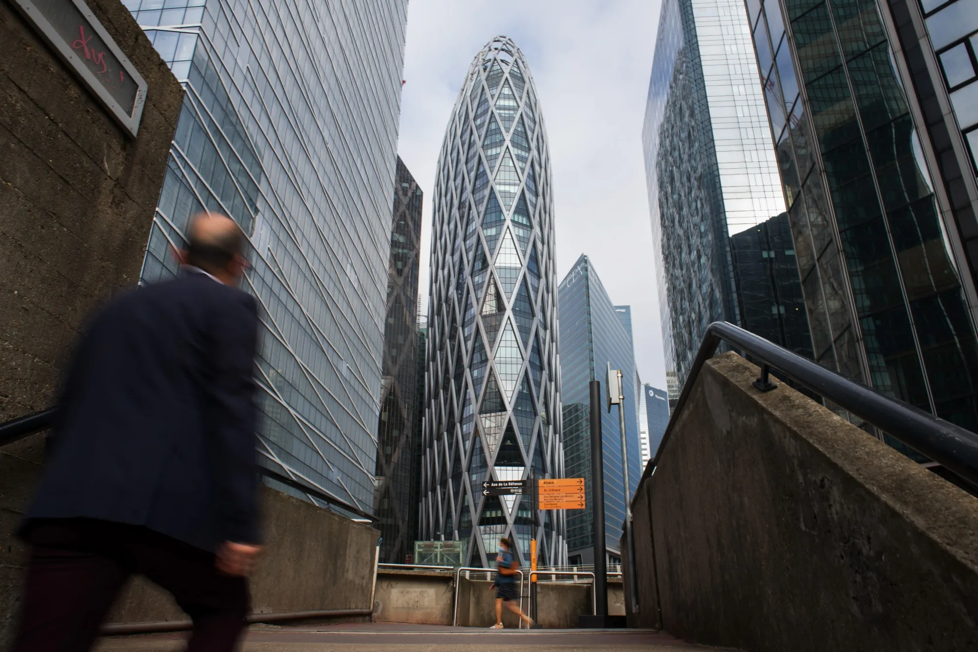 Office workers walk through the La Defense business district in Paris, France,&nbsp;July 27.
