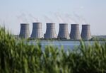Multiple cooling towers stand on the horizon beyond a water reservoir at the Novovoronezh NPP nuclear power station, operated by OAO Rosenergoatom, a unit of Rosatom Corp., in Novovoronezh, Russia, on Wednesday, June 3, 2015.