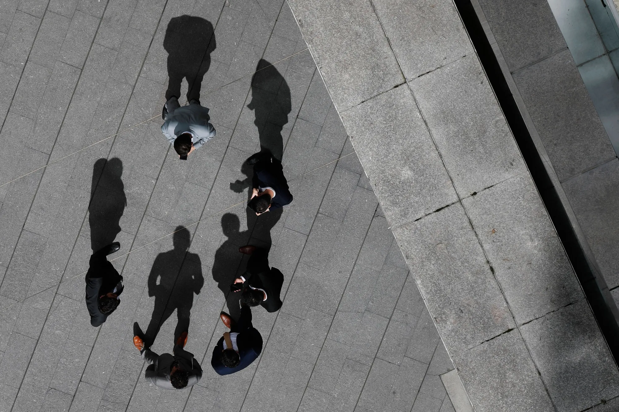 Office workers talk outside an office building in Bogota, Colombia.&nbsp;