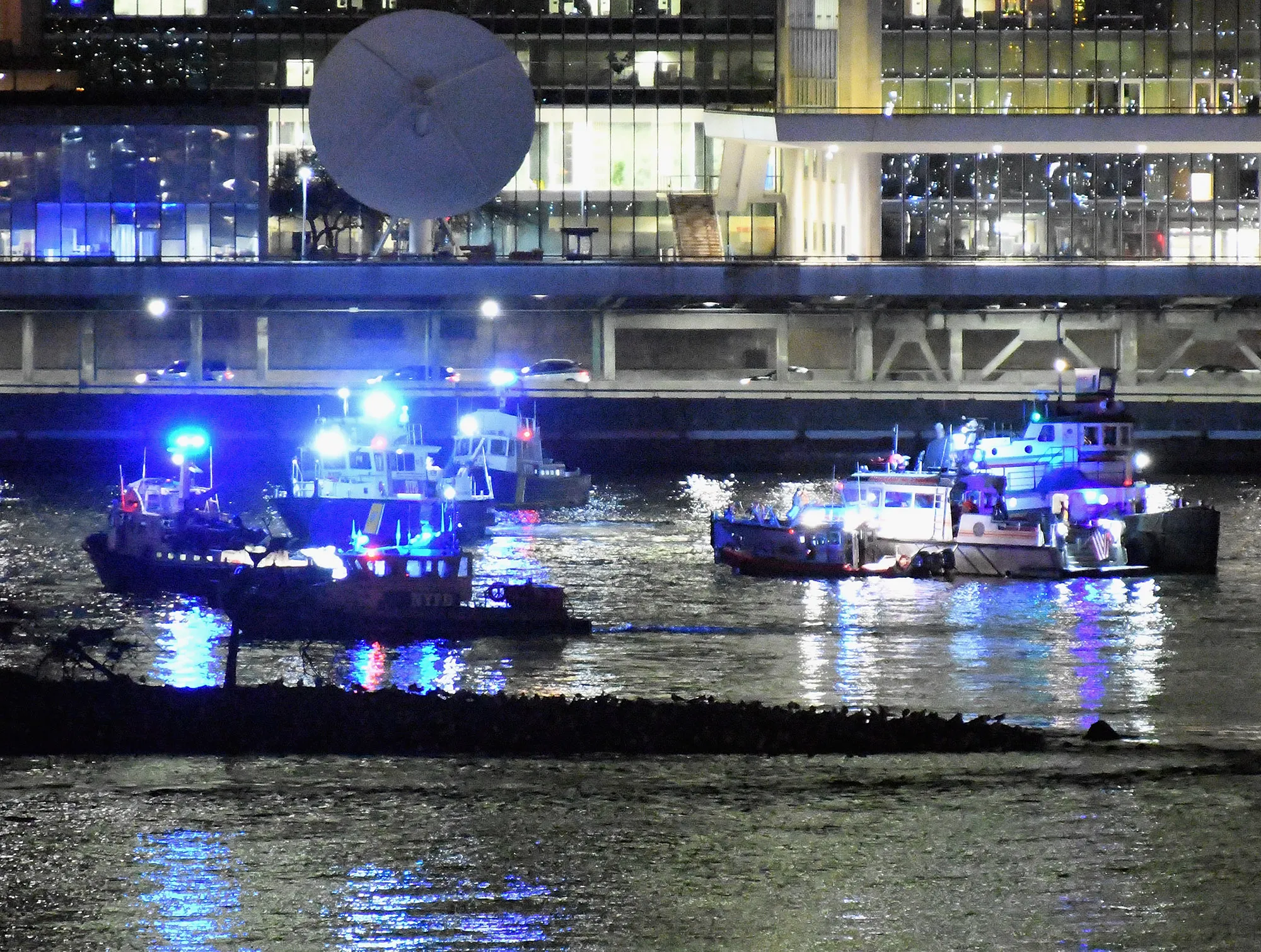 Rescue boats after a helicopter crashed in the East River on March 11, 2018.