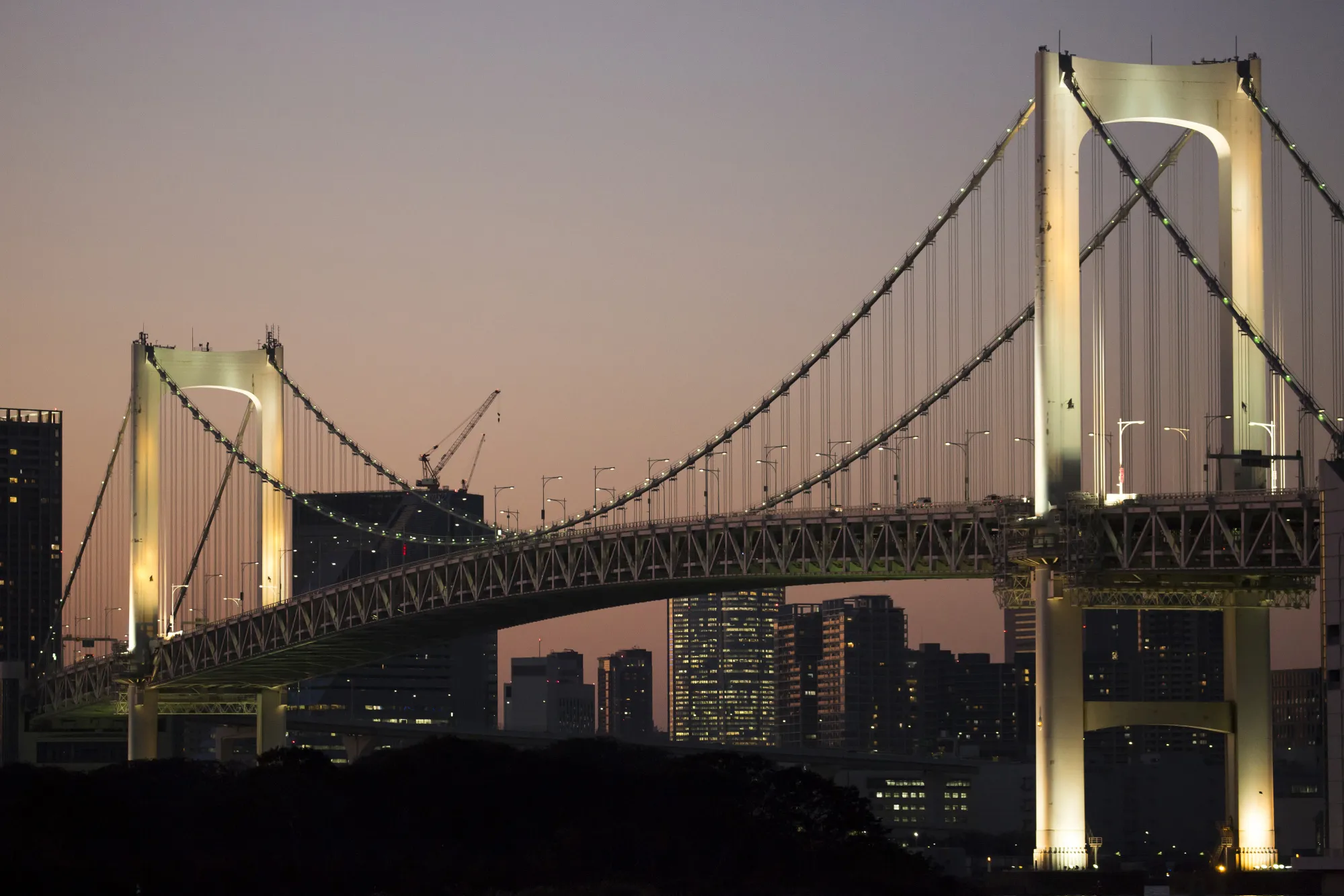 The Rainbow Bridge stands illuminated at dusk in Tokyo, Japan, on Monday, Nov. 6, 2017. The Japanese Cabinet Office is scheduled to release third-quarter gross domestic product (GDP) data on Nov. 15, 2017.