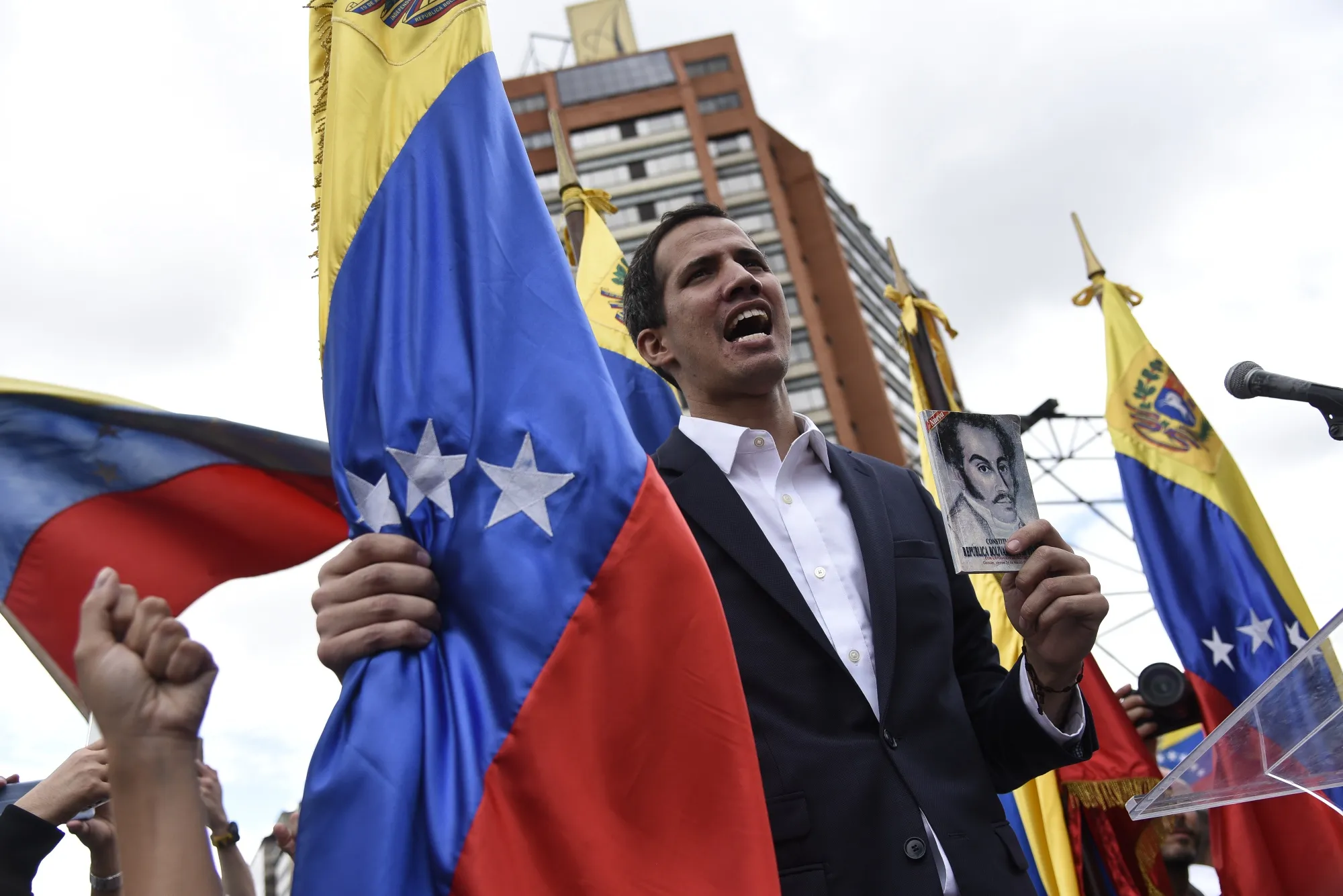 Juan Guaido, president of the National Assembly, sings the national anthem during a pro-opposition rally in Caracas.
