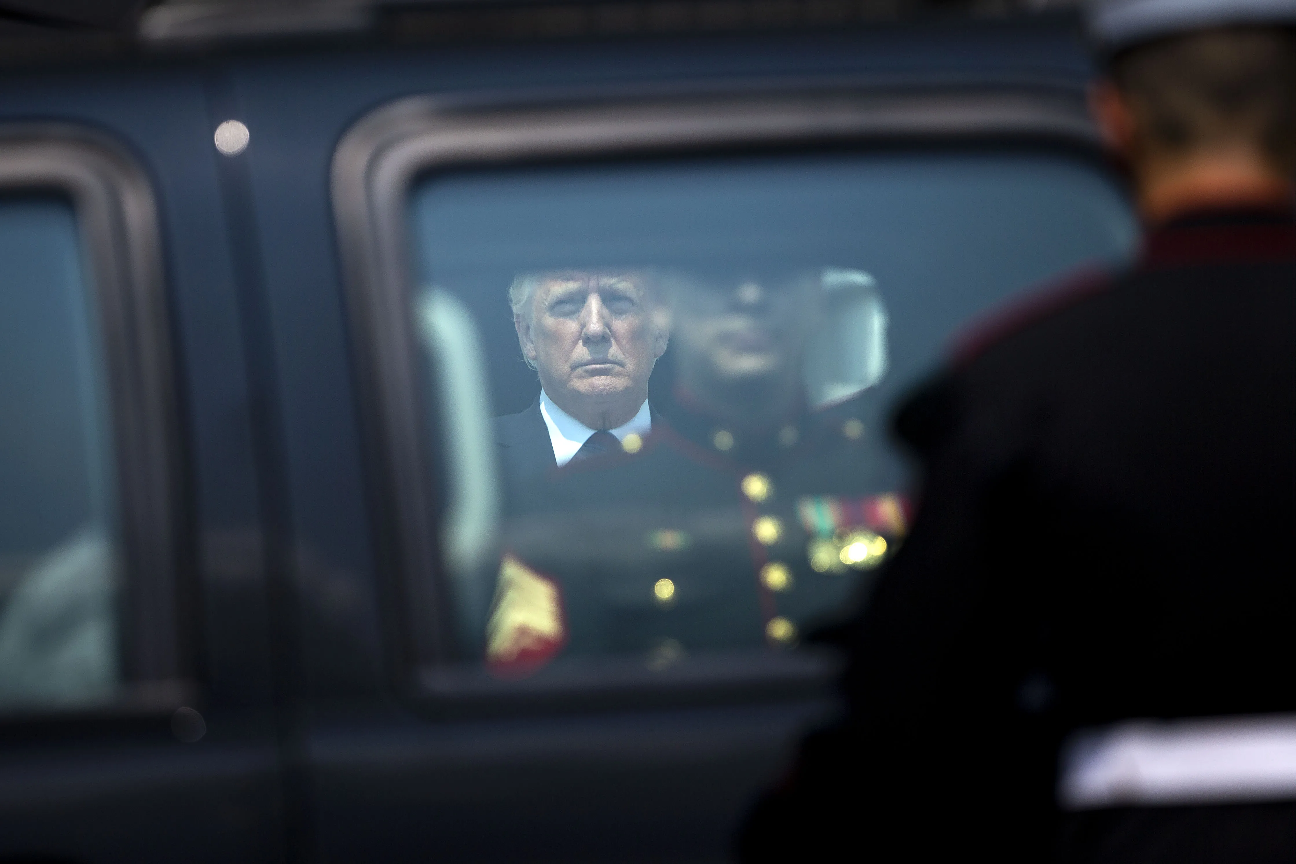 Donald Trump waits outside the White House.