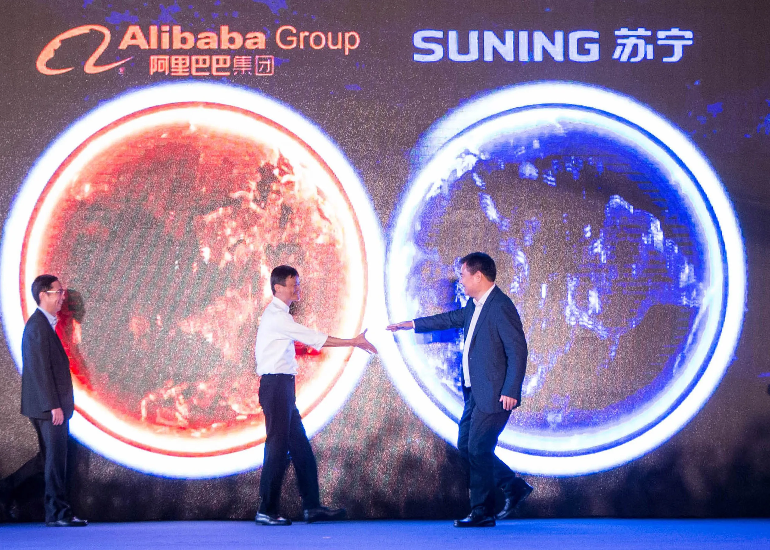 Jack Ma, center left, walks towards Zhang Jindong at a conference announcing the two companies’ cooperation in Nanjing, China, in 2015.