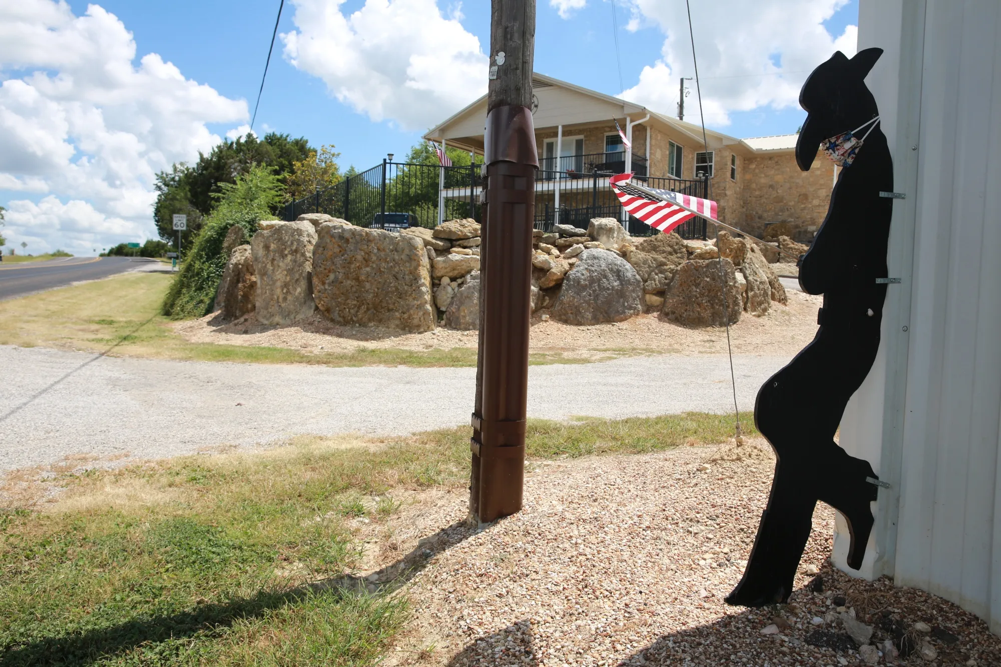 A cowboy cut-out wears a face mask near Lake Whitney, Texas,&nbsp;on&nbsp;Thursday.