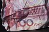 A crumpled Chinese one-hundred yuan banknote in Hong Kong, China.