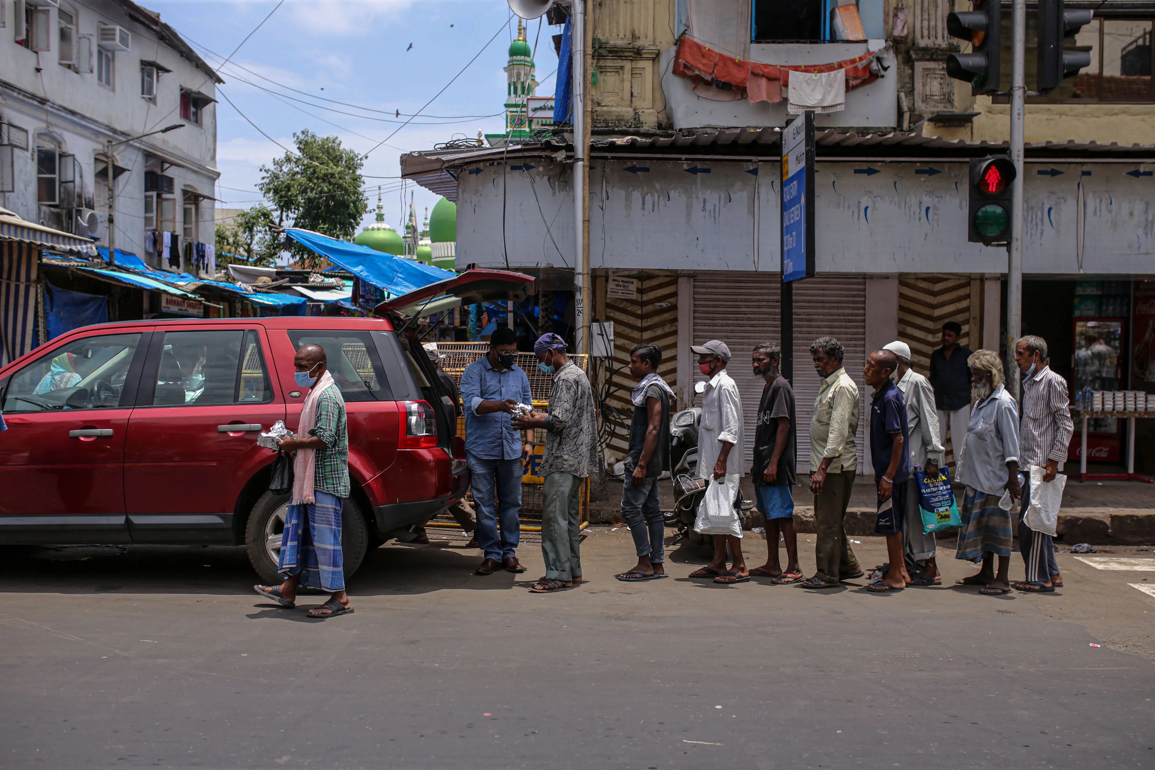 A Khaana Chahiye volunteer distributes free meals in Mumbai on July 7.