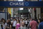 Pedestrians pass in front of a JPMorgan Chase &amp; Co. bank branch in New York.