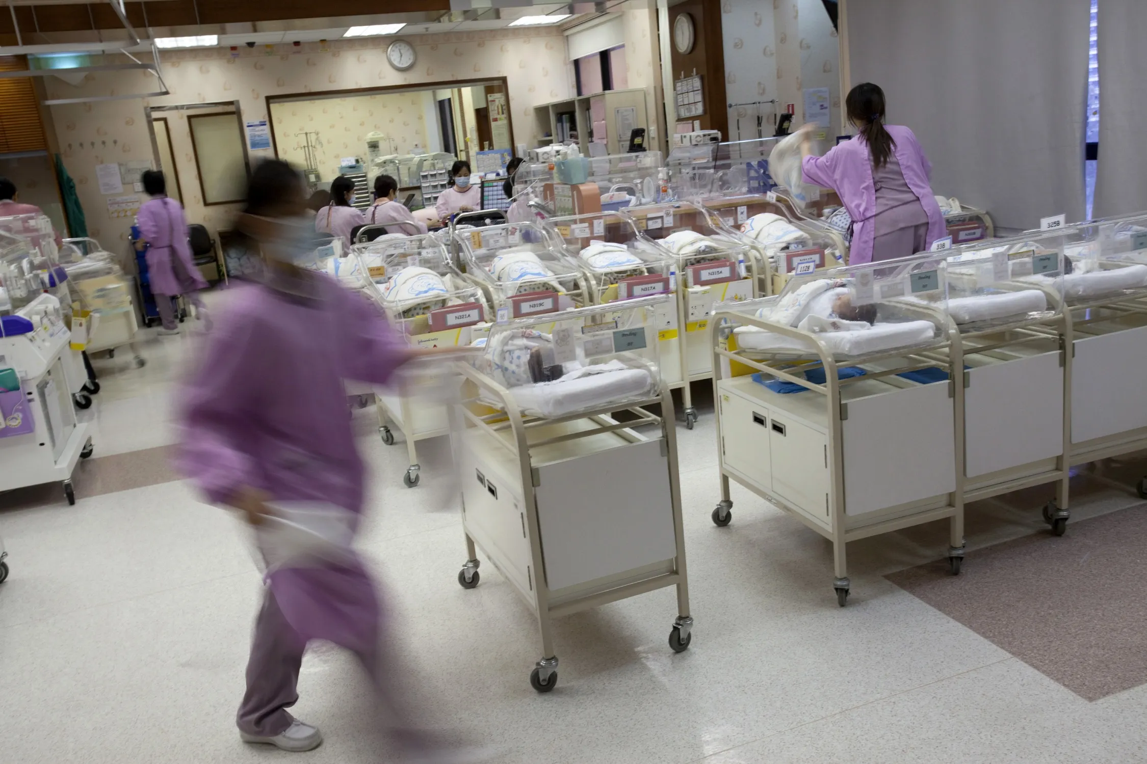 Hospital staff attend to new born babies in the nursery ward of the Union Hospital in Hong Kong, China, on Tuesday, Oct. 18, 2011. The number of babies born in Hong Kong almost doubled in the decade to 2010, thanks to 232,536 babies born to mainland mothers, according to the city's Census and Statistics Department.