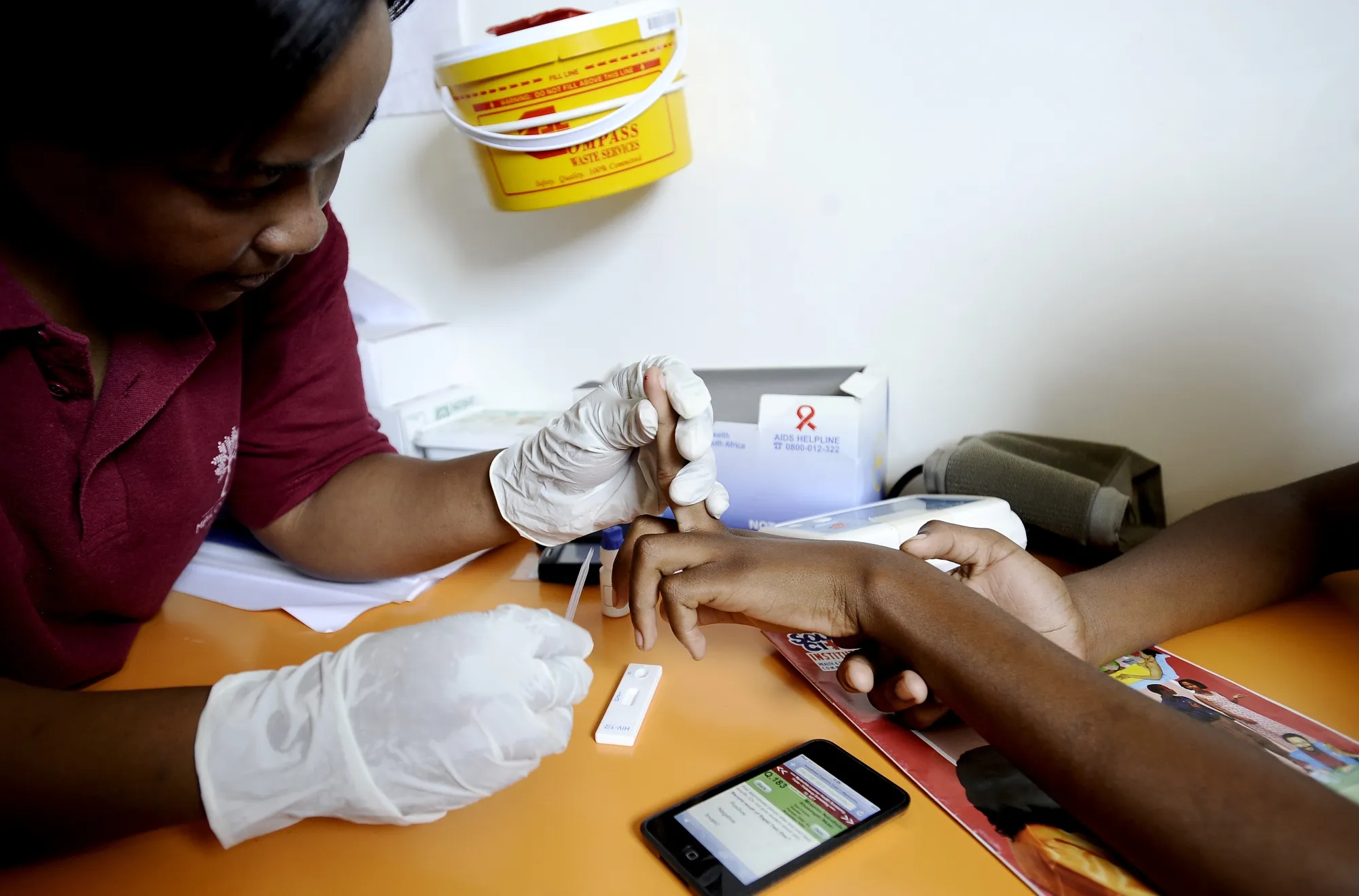 A nurse takes a blood sample in a mobile clinic set up to test students for HIV in Kwazulu Natal, South Africa, in 2011.
