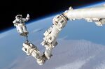 An Astronaut is anchored to the Canadarm2 on the International Space Station in 2005.