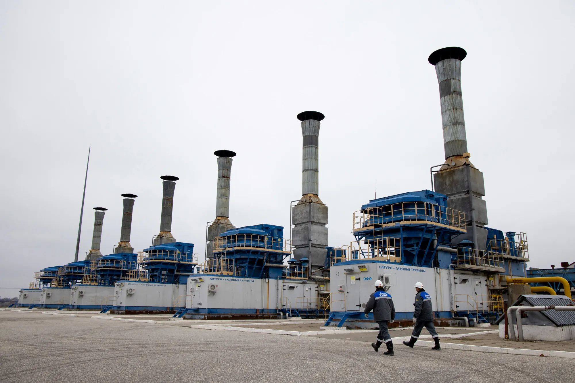 Workers head towards gas compressor units at the Kasimovskoye underground gas storage facility, operated by Gazprom PJSC, in Kasimov, Russia.