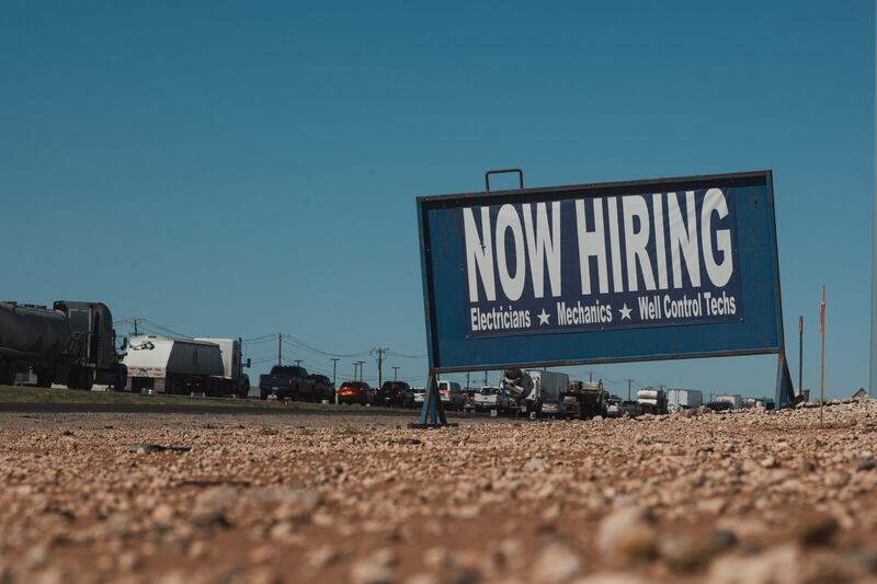 A "Now Hiring" sign along the highway in Midland, Texas, US, on Thursday, April 27, 2023.