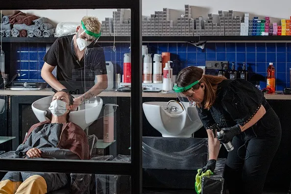 What’s your comfort level? Above: A hair salon reopens&nbsp;in Spain.
