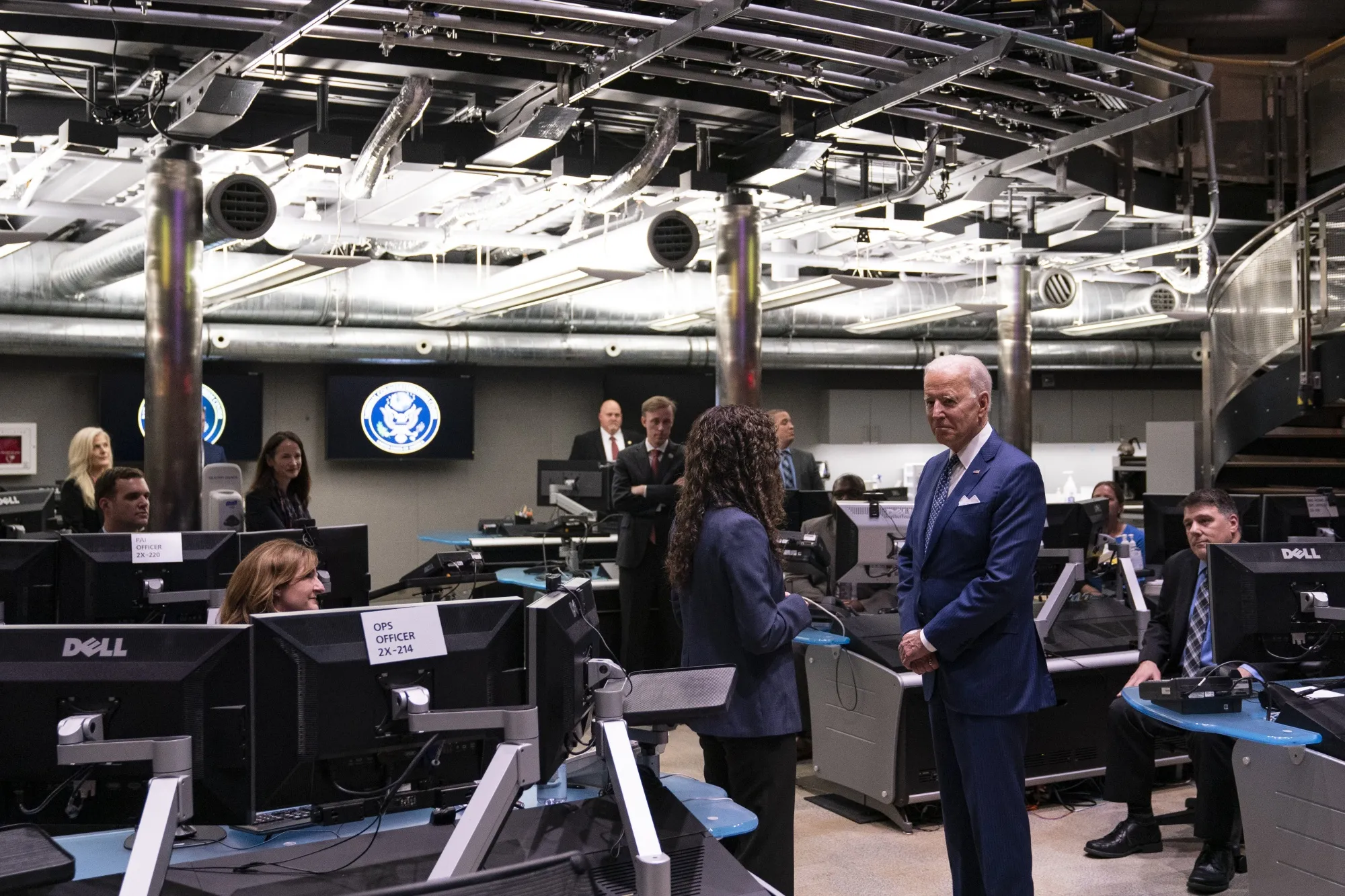 Joe Biden speaks with Christy Abizaid, director of the National Counterterrorism Center, while visiting the Office of the Director Of National Intelligence headquarters in McLean, Virginia.