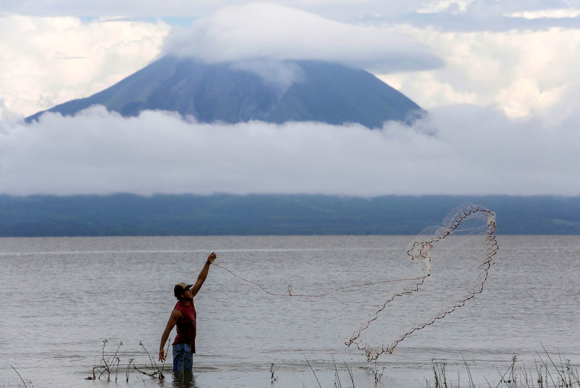 A fisherman throws a fishing net at Lake Cocibolca in La Virgen, Nicaragua.
