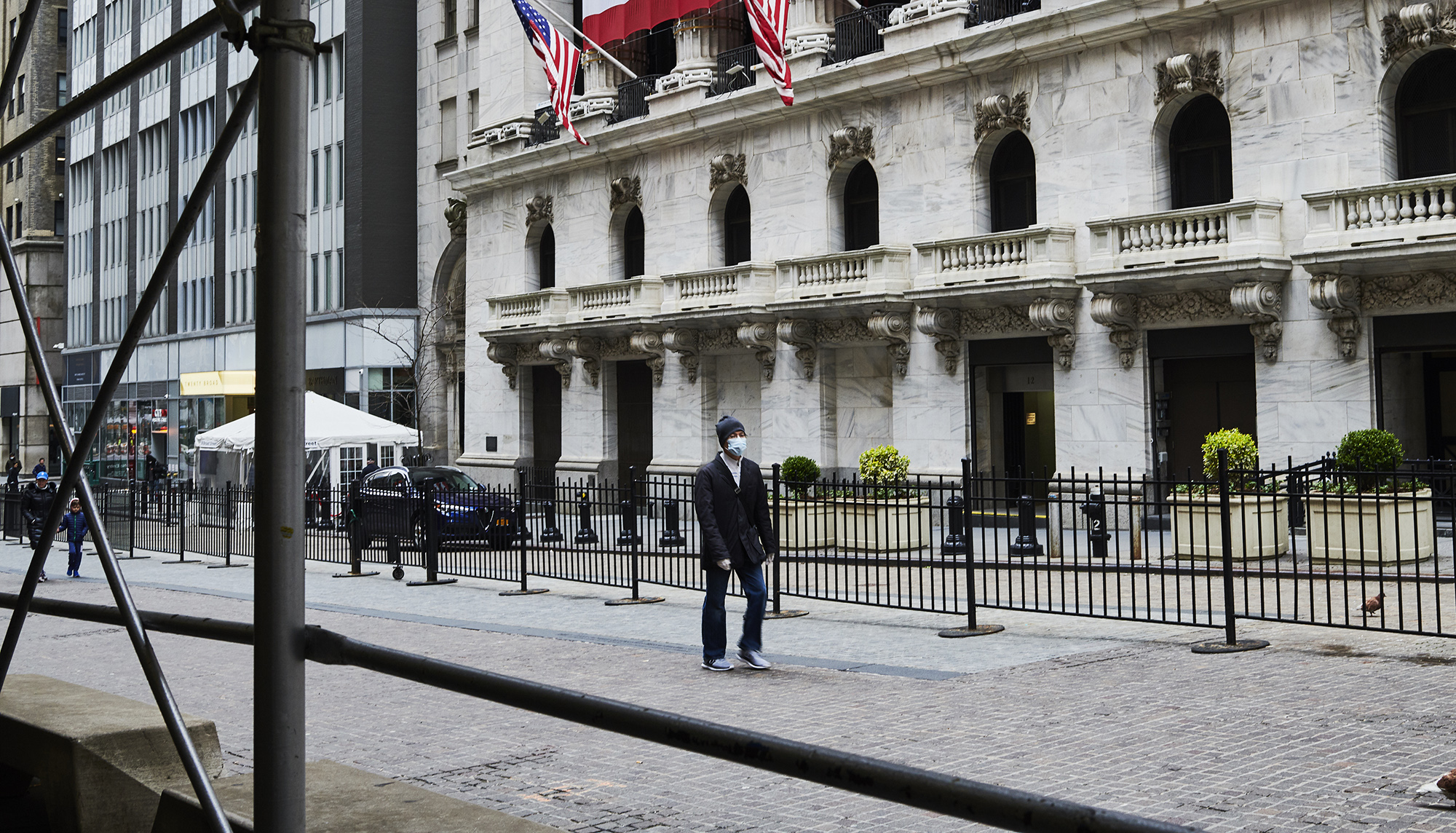 A pedestrian wearing a protective mask walks in New York&nbsp;on&nbsp;March 30.