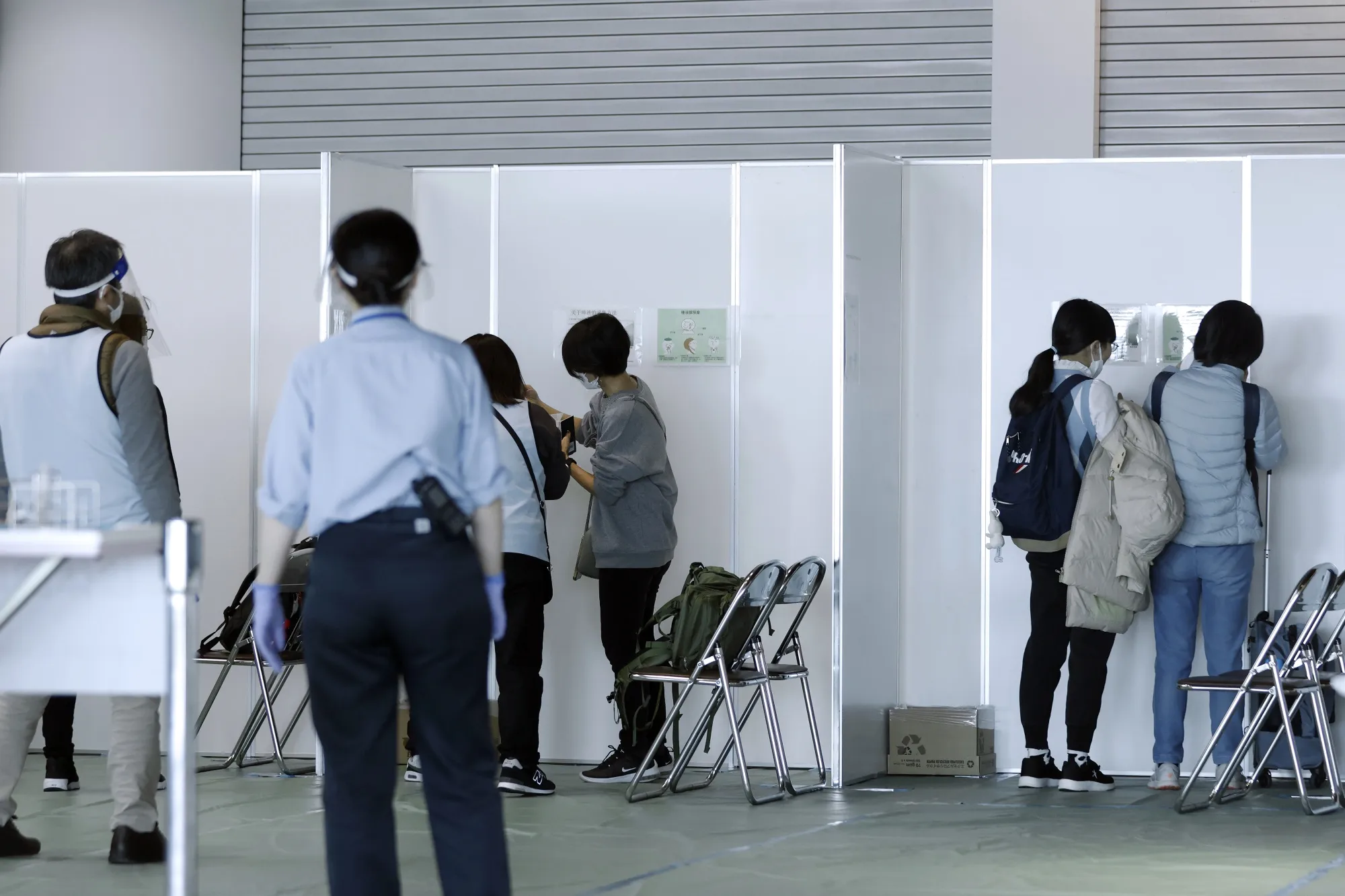 Travelers from Shanghai, China, take a Covid-19 test at Narita International Airport in Japan.
