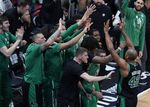 Boston Celtics center Al Horford (42) is congratulated by his teammates during the second half of Game 5 of the NBA basketball Eastern Conference finals playoff series against the Miami Heat, Wednesday, May 25, 2022, in Miami. (AP Photo/Wilfredo Lee)