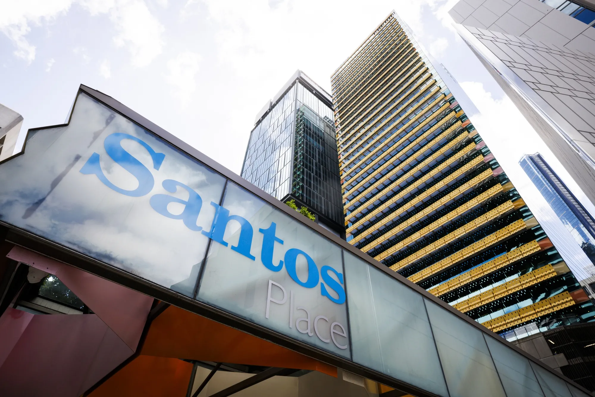 The Santos Ltd. logo displayed at an entrance of Santos Place building, which houses the company's office, in Brisbane, Australia.